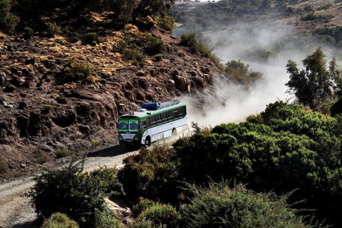 A bus navigates a dusty road in Semien Mountain National Park