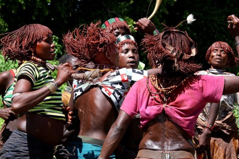 Dancing Hamer woman, united in dance celebration, in a ritual initiation session, Turmi, Ethiopia