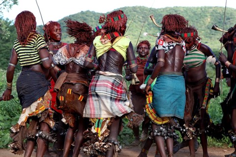 Hamer woman, wearing traditional clothes, dancing in circles, part of an initiation ritual, Turmi,