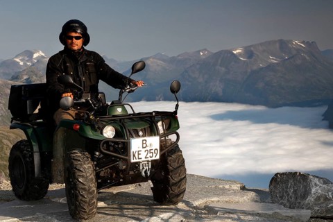 Person on ATV enjoying breathtaking views of Dalsnibba in Geirangerfjord, Dalsnibba,