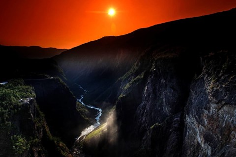 Spectacular view of Vøringsfossen at sunset in Måbødal, surrounded by dramatic rock faces,