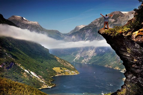 Spectacular views of the Geiranger Fjord from Flydalsjuvet with snow-capped peaks and deep water