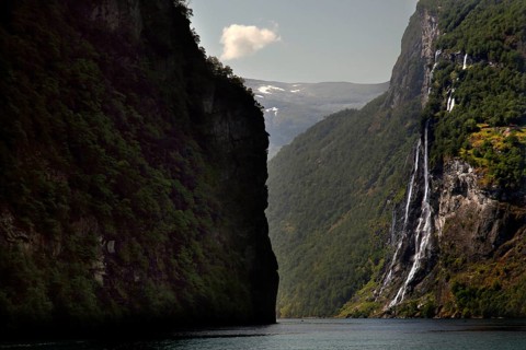 Dramatic waterfall falling in Geirangerfjord surrounded by steep cliffs, Geirangerfjord, Møre og