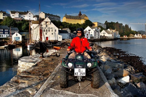 ATV rider on the dock in front of the fishing museum in Ålesund in sunny weather, Ålesund, Møre og
