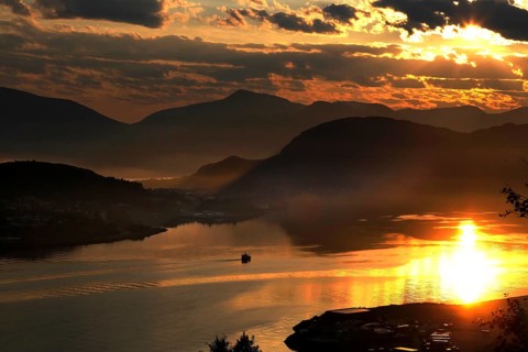Impressive sunset with reflecting water from Kniven viewpoint in Ålesund, Ålesund, Norway