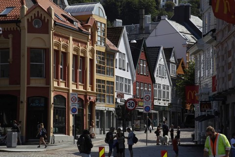 Scenic city view with historic colorful buildings and passers-by, Bergen, Hordaland, Norway