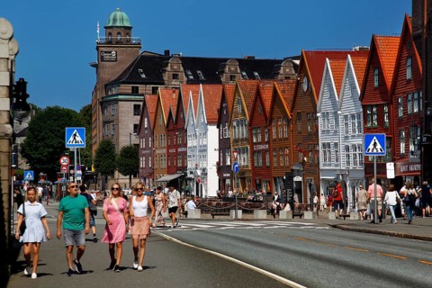 Summer scene of people strolling through Bergen Hanseatic Quarter, Bergen, Norway
