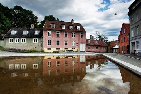 Historic wooden houses in Oslo reflected in a quiet water basin, Oslo, Damstredet, Norway