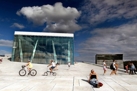 Cyclists and pedestrians on the white surface of Oslo Opera, Oslo, Bjøvika, Norway