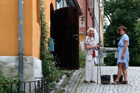 Two woman talking on the charming paved street in Oslo, Oslo, Damstredet, Norway