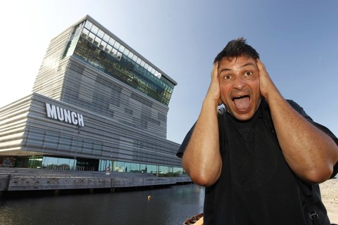 A man poses in front of the Munch Museum in a well-known screaming pose, Oslo, Bjøvika, Norway