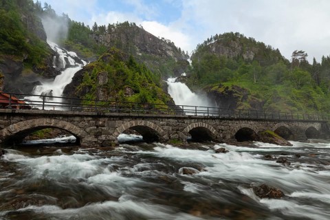 Summer day visiting Låtefossen falls near Odda, flowing water and green valley, Vestland, Norway