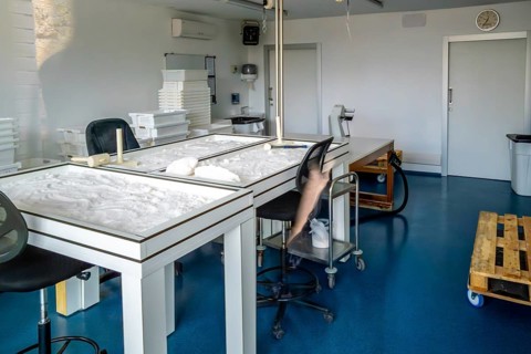 Interior view of the anana salt flats laboratory showing tables with natural salt drying process,
