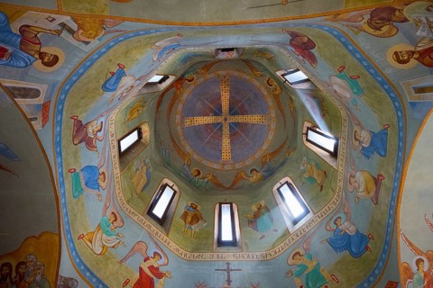 Detailed frescoes in the dome of a church depicting angels and religious figures, domed church by
