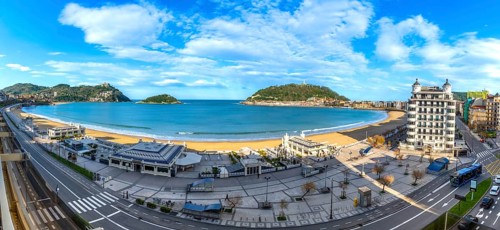 Panoramic view of la concha bay in san sebastian, spain, featuring the sandy beach, city