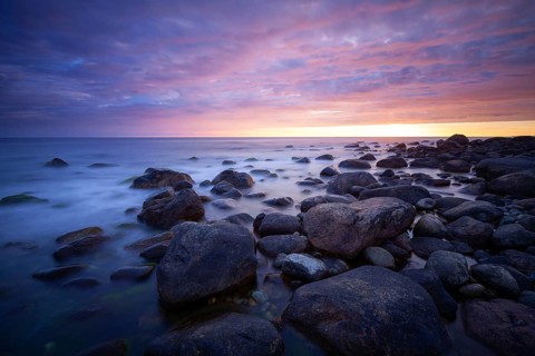 Rocky bay under a dramatic glowing sky at the coast. unset, Vigrestad, Rogaland, Norway