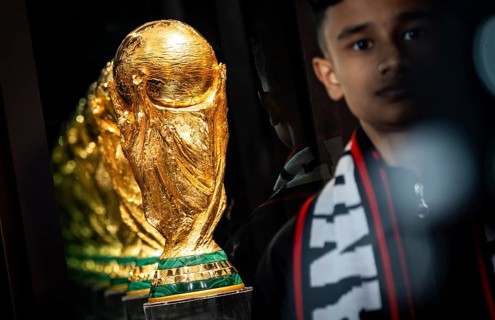 A football fan poses for a photograph with the original FIFA World Cup 2026 Trophy during the