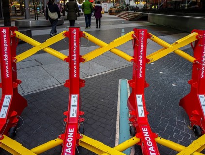 Massive metal access barriers in red and yellow at Center Potsdamer Platz, Berlin, Germany