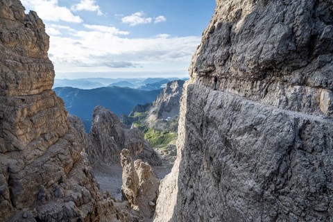 View from the Bocca degli Armi gap, mountaineers on a rock band on the Via Ferrata Bocciere