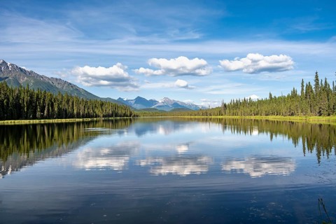 Mountains are reflected in idyllic Crystal Lake, McCarthy Highway, Wrangell St. Elias National