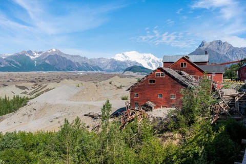 Red Kennicott buildings in front of mountainous landscape, Kennicott Concentration Mill to extract