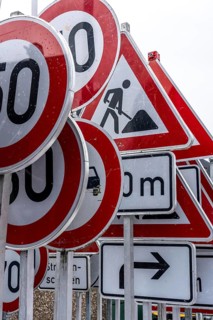 Storage for traffic signs in the yard of a road maintenance department, various signs with
