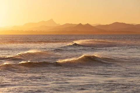Evening light at Cape Byron with view to Mount Warning and sunlit hinterland, New South Wales,