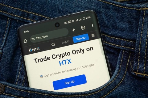 Dhaka, Bangladesh- 15 June 2025: A smartphone displaying the HTX web interface peeks out of a denim