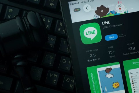 Dhaka, Bangladesh- 28 Oct 2025: An iPad displaying the LINE app against a judge's gavel and dark