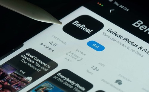 Dhaka, Bangladesh- 30 Oct 2025: BeReal app on a iPad screen with a pen pointing at the install
