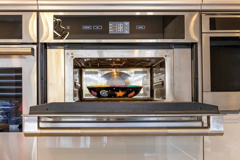 Modern kitchenware and microwave in luxury designer kitchen. Food preparation with expensive