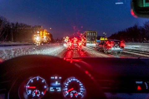 Driving in winter, in snow, motorway, rear lights, brake lights, speedometer, cockpit