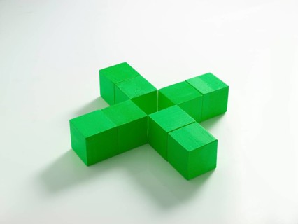 8 green wooden cubes against a white background