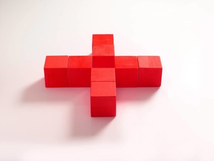 8 red wooden cubes against a white background