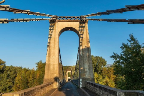 Suspension bridge of Coudes village on river Allier. Puy de Dome. Auvergne Rhone Alpes. France