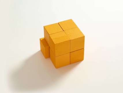 8 yellow wooden cubes against a white background