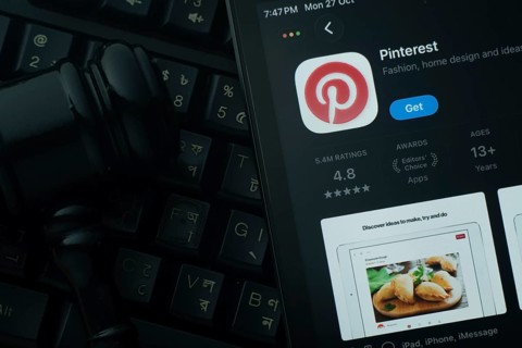 Dhaka, Bangladesh- 28 Oct 2025: An iPad displaying the Pinterest app against a judge's gavel and