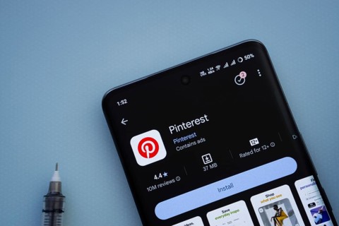 Dhaka, Bangladesh- 29 May 2025: On a blue surface, a smartphone displays the Pinterest app within