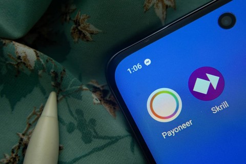 Dhaka, Bangladesh- 07 May 2025: Payoneer and Skrill app icon is seen on smartphone