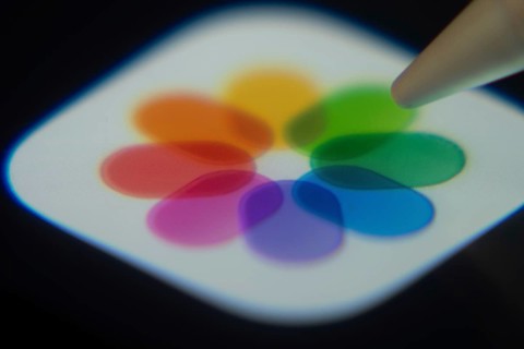 Dhaka, Bangladesh- 06 Dec 2025: Close-up of the Apple Photos app on a screen with a stylus pointing