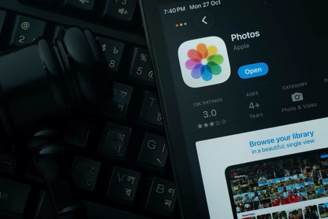 Dhaka, Bangladesh- 28 Oct 2025: An iPad displaying the Apple Photos app against a judge's gavel and