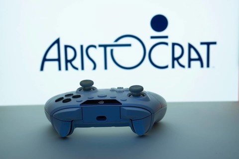 Dhaka, Bangladesh- 08 Apr 2025: A gaming controller in front of a Aristocrat screen
