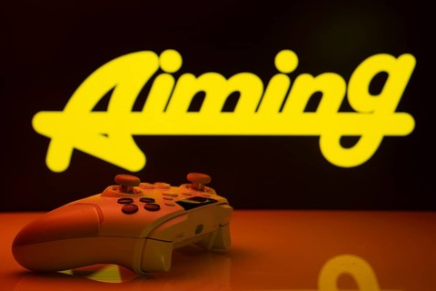 Dhaka, Bangladesh- 20 Mar 2025: A close-up of a white gamepad with the Aiming Inc seen on screen in