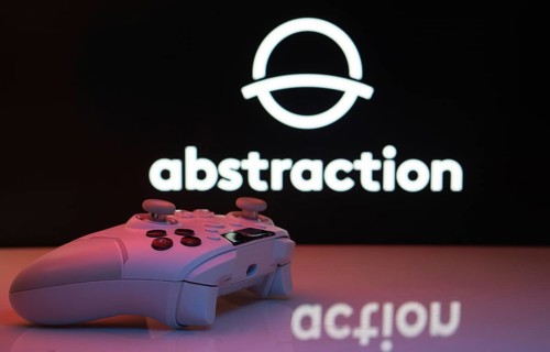 Dhaka, Bangladesh- 20 Mar 2025: A close-up of a white gamepad with the Abstraction seen on screen