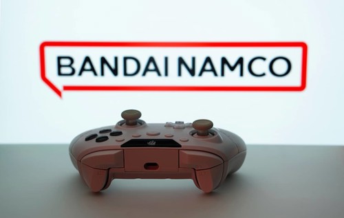 Dhaka, Bangladesh- 08 Apr 2025: A gaming controller in front of a Bandai Namco Entertainment screen