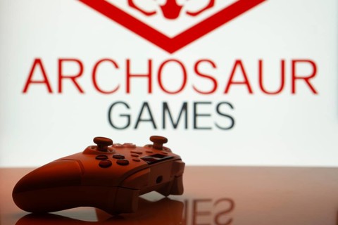 Dhaka, Bangladesh- 20 Mar 2025: A close-up of a white gamepad with the Archosaur Games seen on