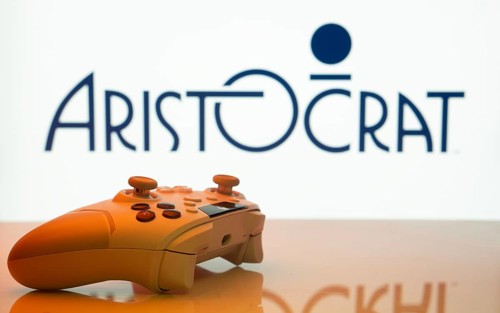 Dhaka, Bangladesh- 20 Mar 2025: A close-up of a white gamepad with the Aristocrat seen on screen in