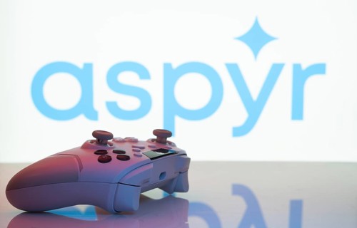 Dhaka, Bangladesh- 20 Mar 2025: A close-up of a white gamepad with the Aspyr seen on screen in the