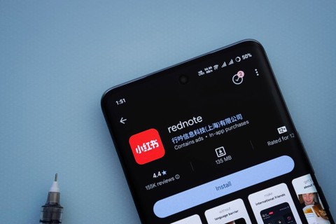 Dhaka, Bangladesh- 29 May 2025: On a blue surface, a smartphone displays the rednote app within the