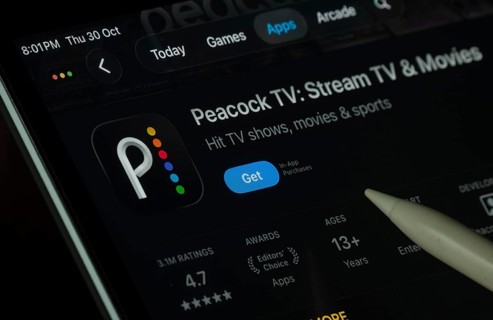 Dhaka, Bangladesh- 30 Oct 2025: Peacock TV app displayed on a iPad screen in dark mode with a